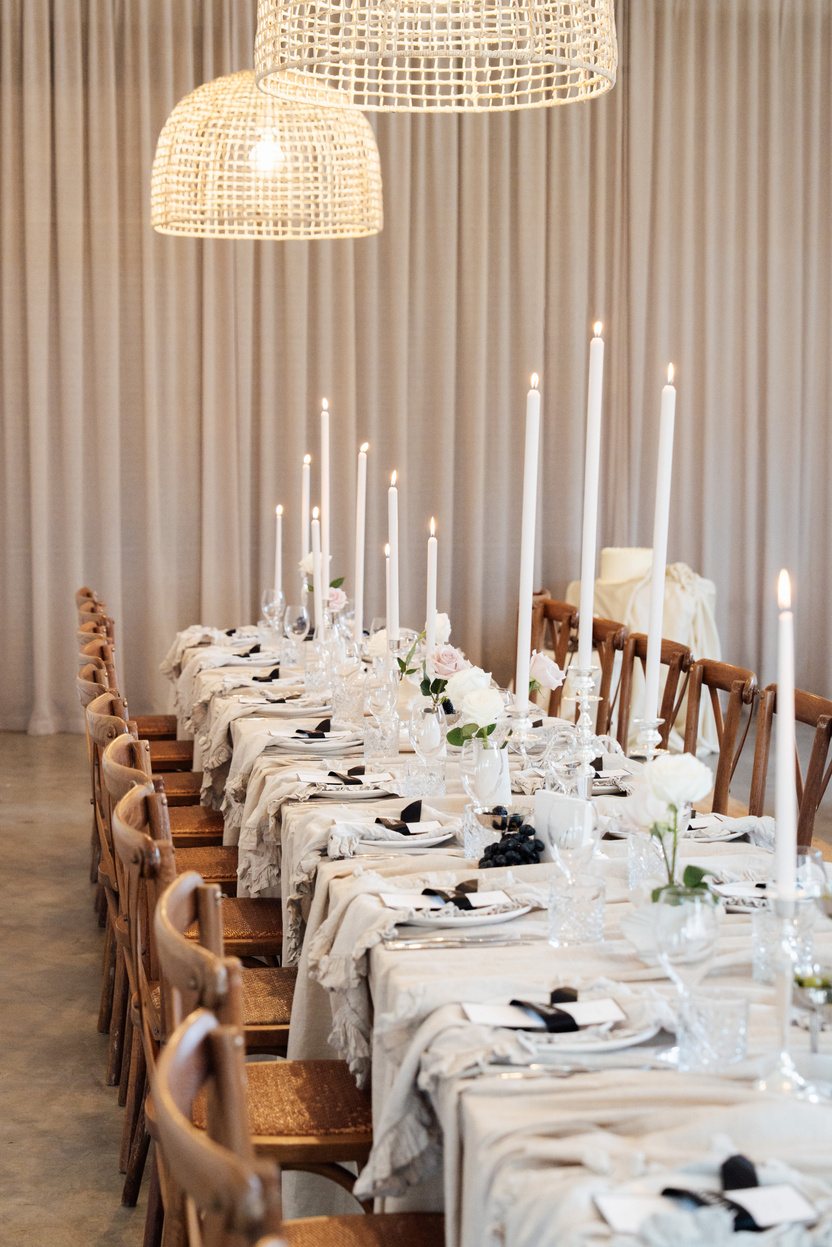 A long table set with tall candles