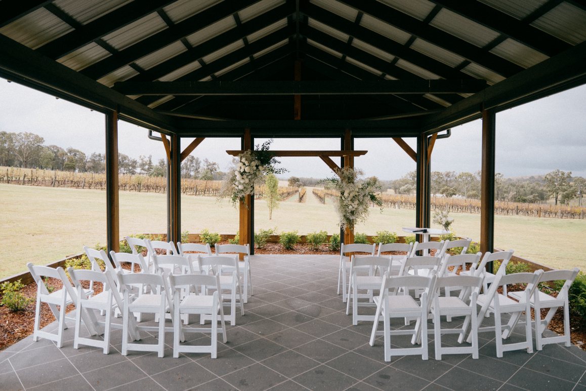 The purpose-built pergola set with white chairs