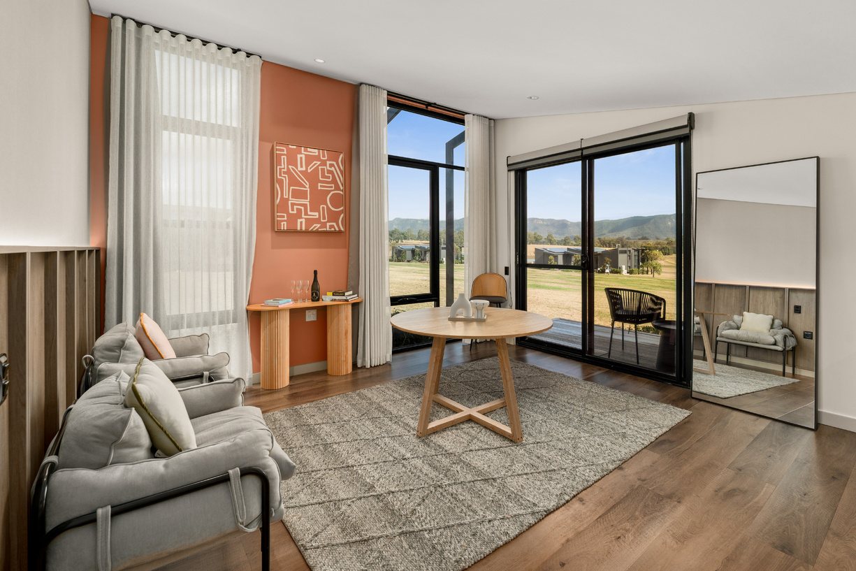 Inside a Lane Retreat studio, a king bed and a wall of glass to the vines